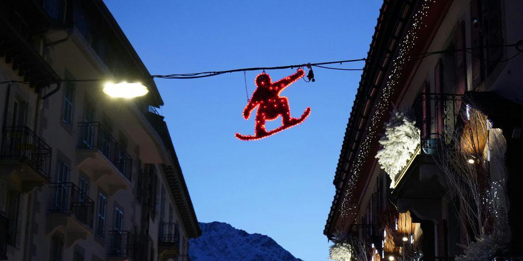 a christmas decoration of a teddy bear hanging from a wire