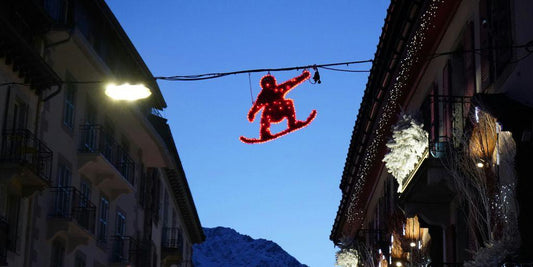 a christmas decoration of a teddy bear hanging from a wire